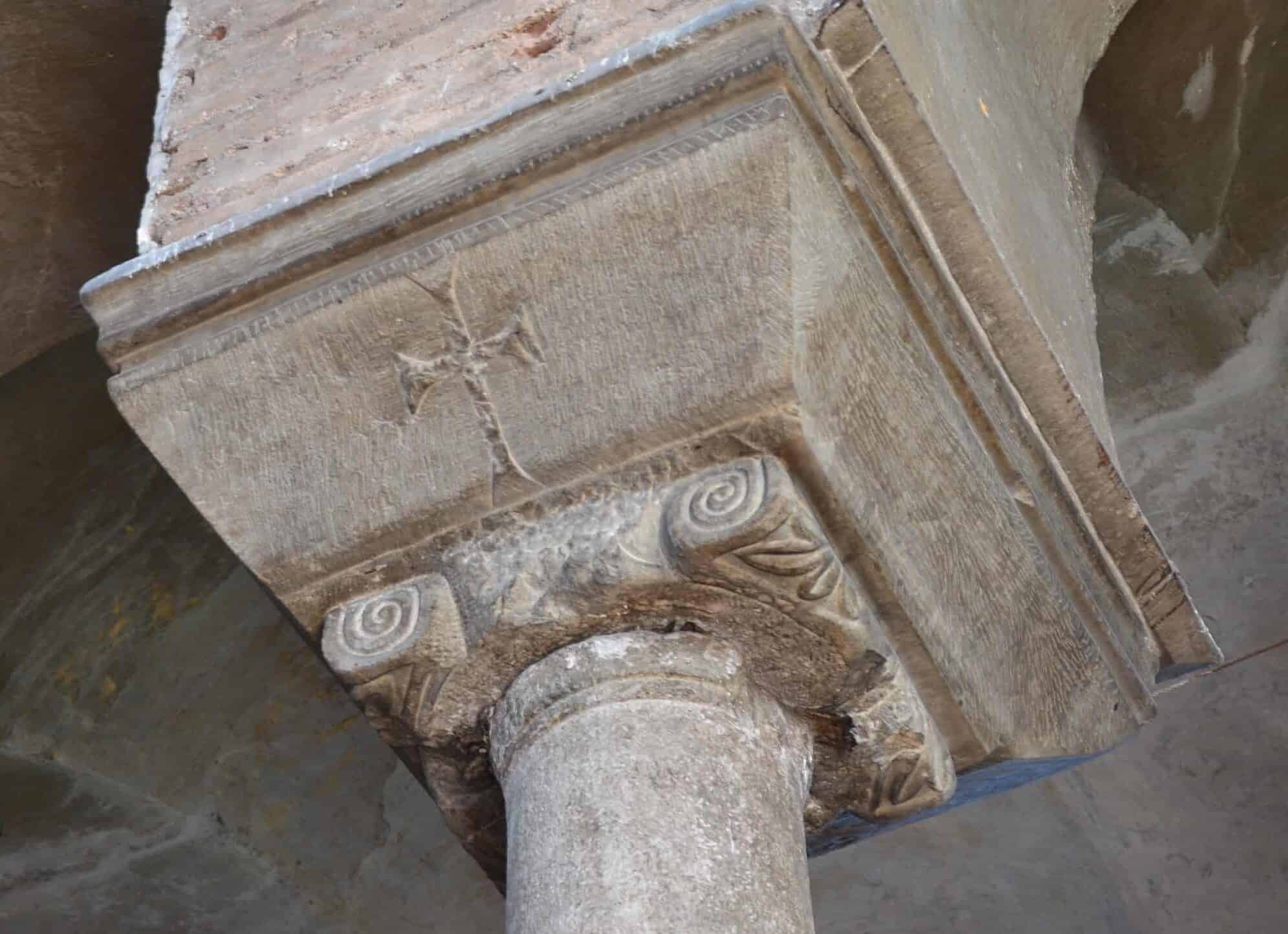 Cross decorating a column capital along the north aisle