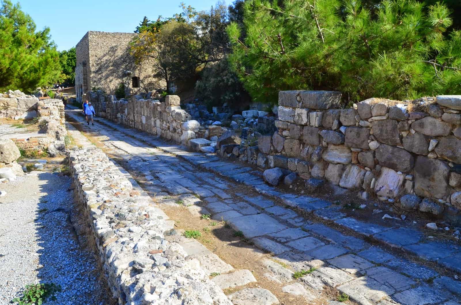 Road with the Nymphaeum at the top left corner in the Western Excavation Area in Kos, Greece