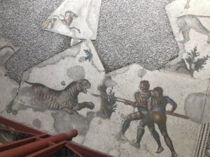 Men hunting a tiger at the Great Palace Mosaics Museum in Istanbul, Turkey