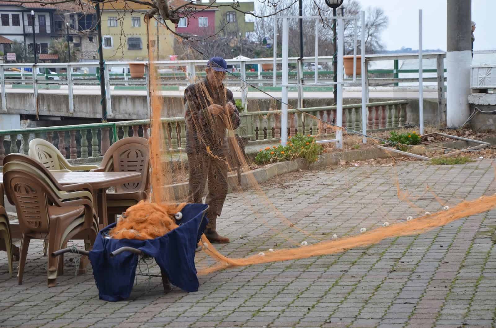 A fisherman preparing his net in Gölyazı, Turkey