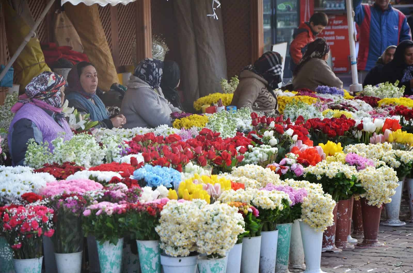 Women selling flowers outside the Üsküdar ferry terminal in Üsküdar, Istanbul, Turkey