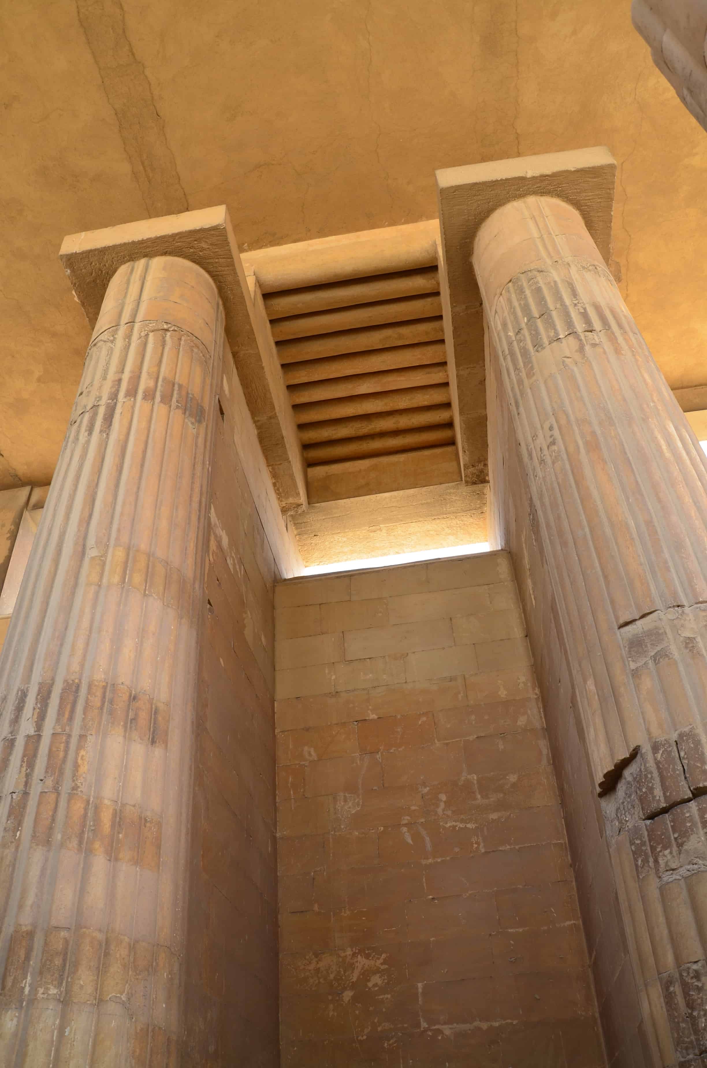 Looking up at the columns in the colonnaded entrance of the Step Pyramid of Djoser at Saqqara, Egypt