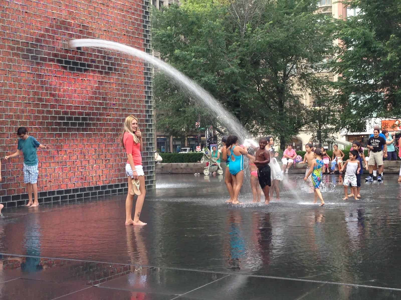 Kids enjoying the Crown Fountain at Millennium Park in Chicago, Illinois