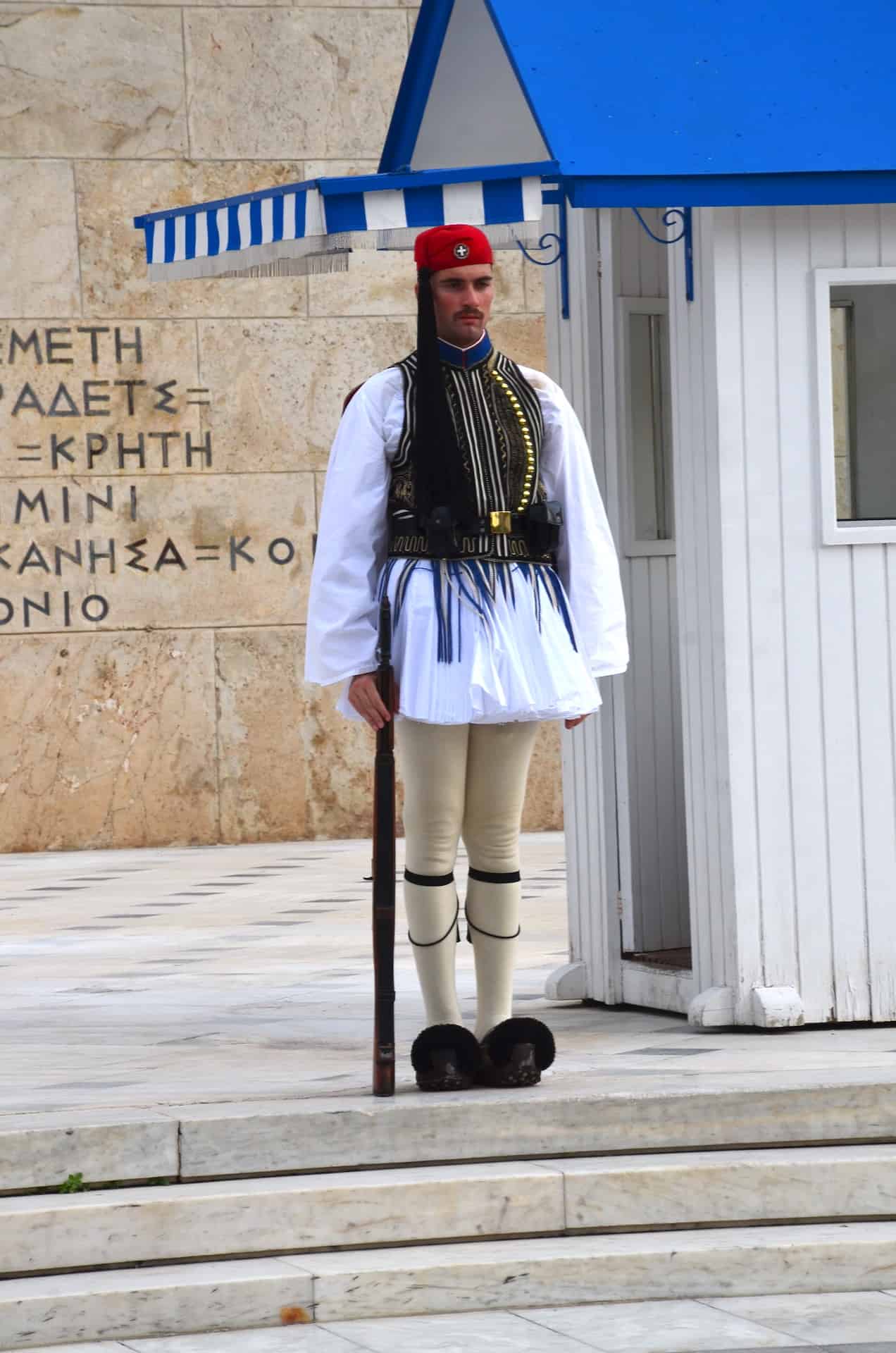 An Evzone in his formal Sunday uniform at the Tomb of the Unknown Soldier in Athens, Greece