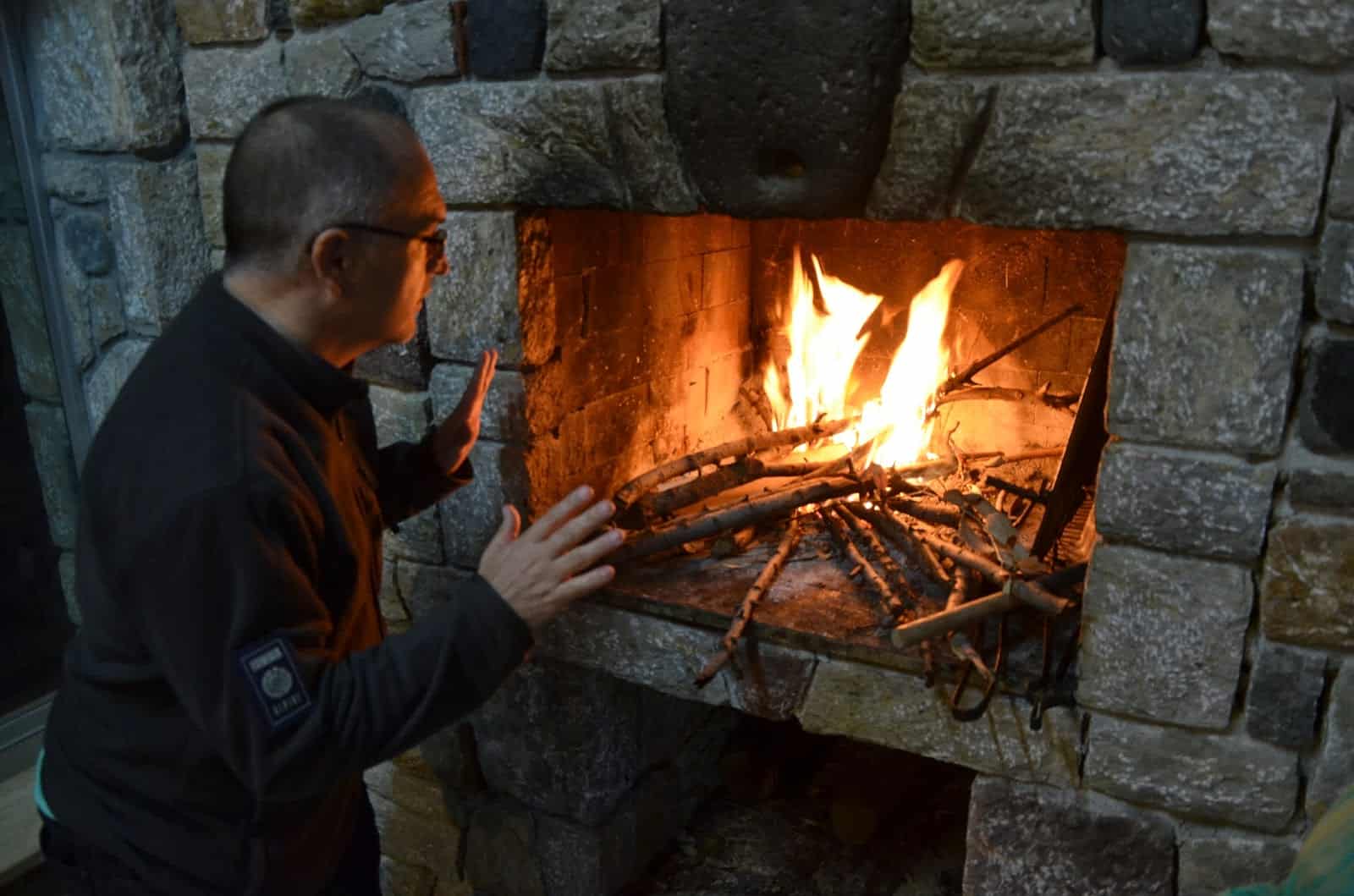 Martin warming up by the fire at Ovabükü, Datça, Turkey