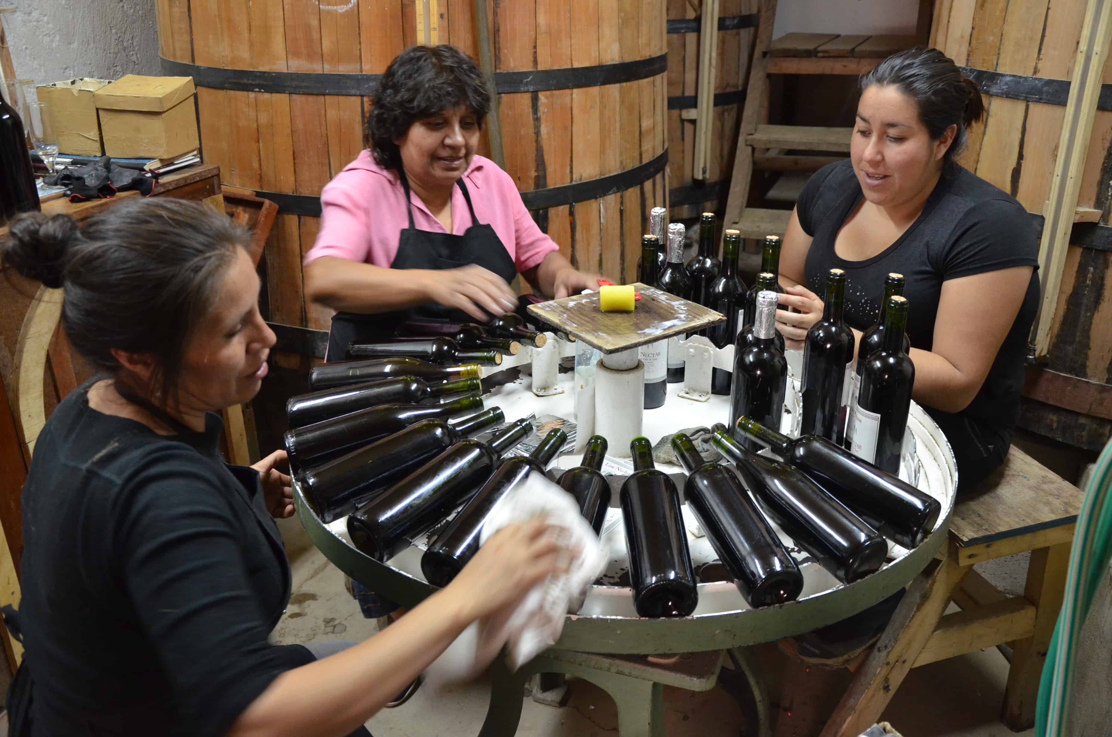 Women preparing bottles for labeling at Los Nichos Distillery in Pisco Elqui, Elqui Valley, Chile