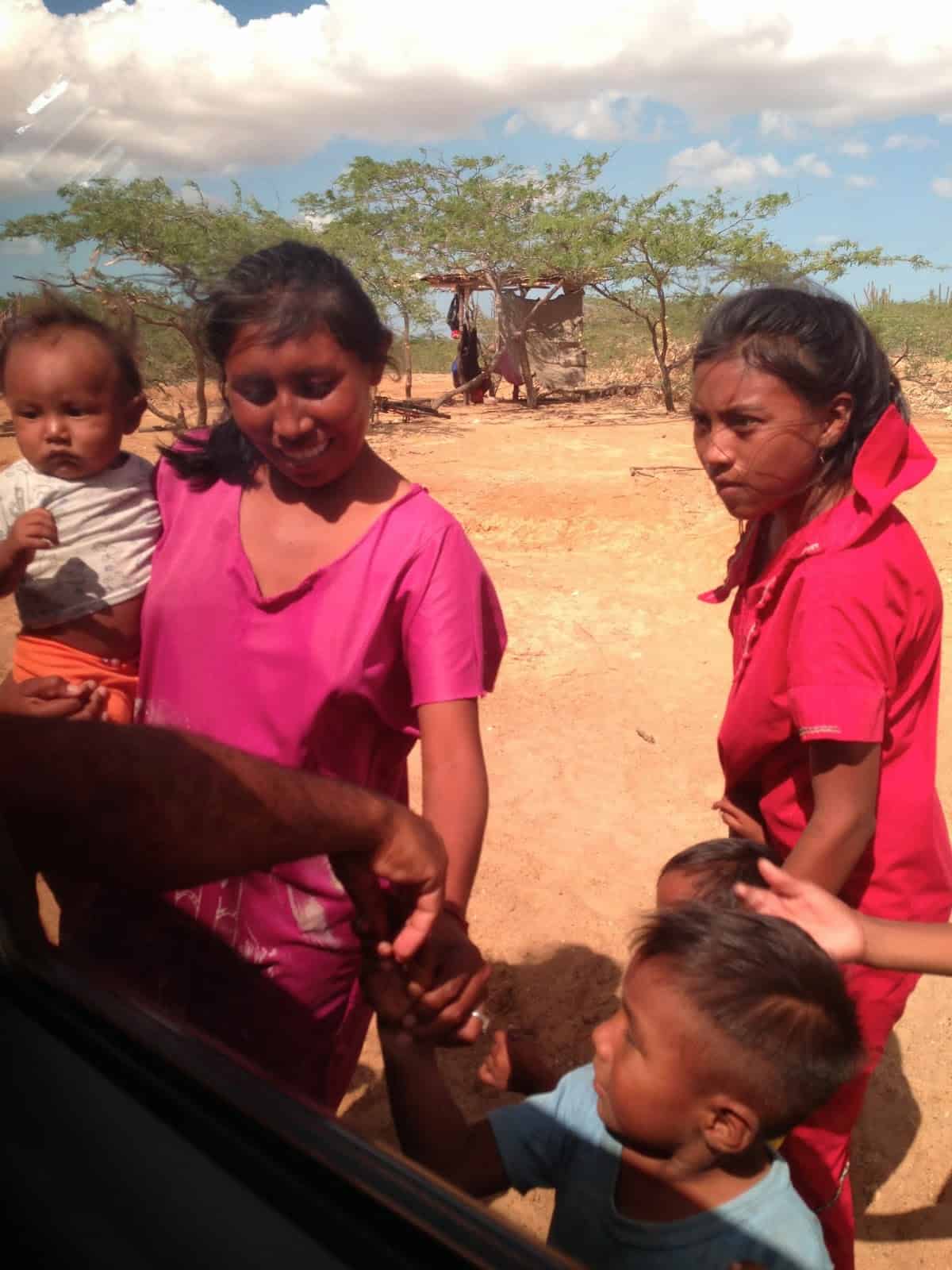 Giving candy and coins to the Wayúu in La Guajira, Colombia