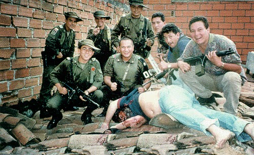 The forces that killed Escobar triumphantly posing over his body Medellín, Colombia.