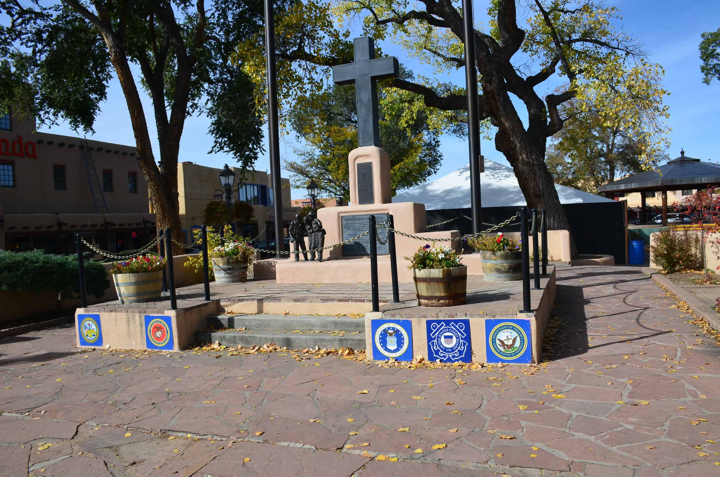 Center of the plaza where the flagpole stands