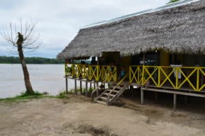 A building on stilts next to the Amazon River