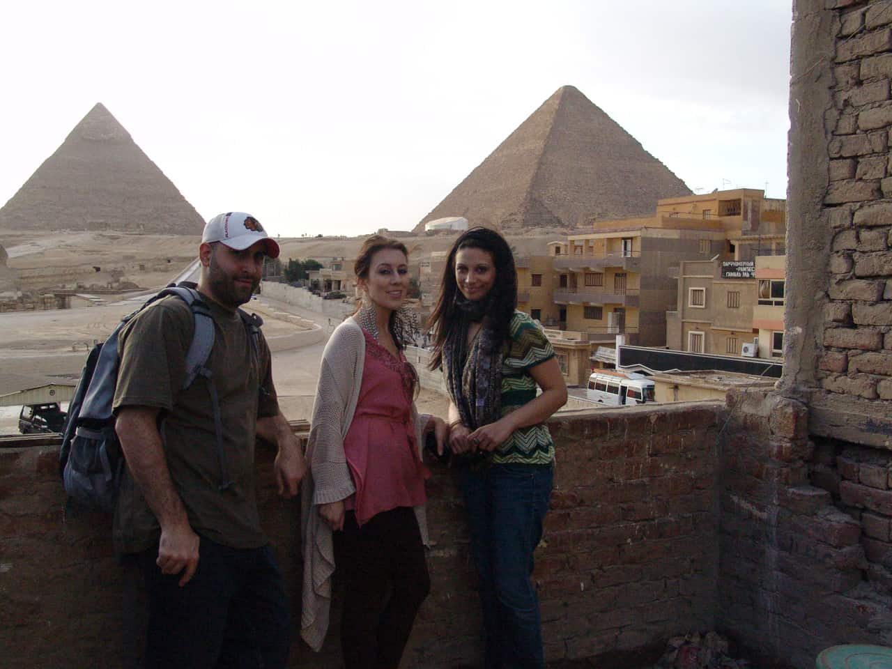 Me, Maria, and Dana posing in front of the pyramids in Giza, Egypt