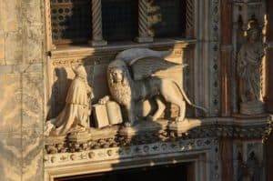 Doge Francesco Foscari kneeling before the Lion of Saint Mark on the Porta della Carta of the Palazzo Ducale in Venice, Italy