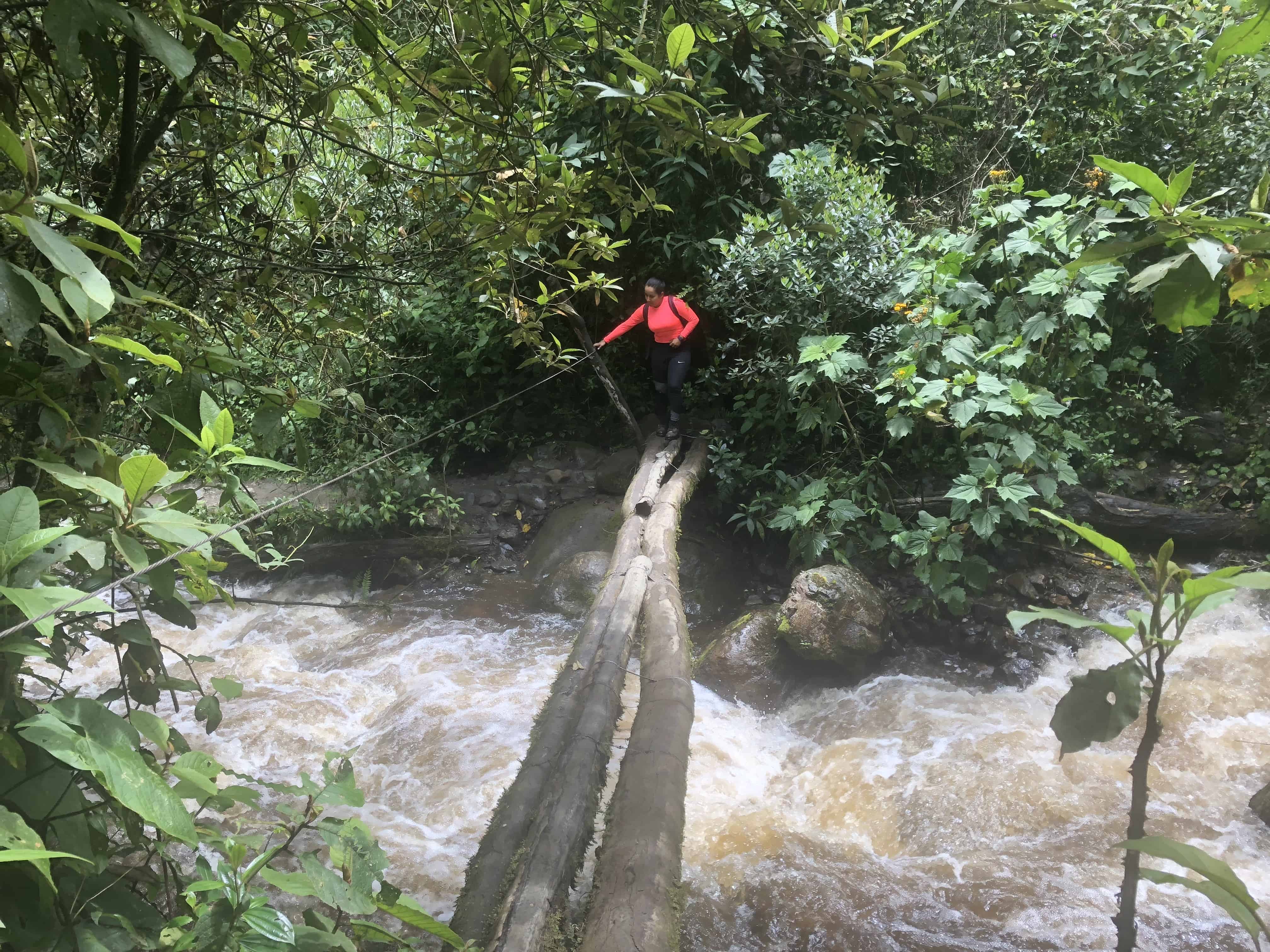 Marisol crossing over the river at Cocora Valley in Quindío, Colombia