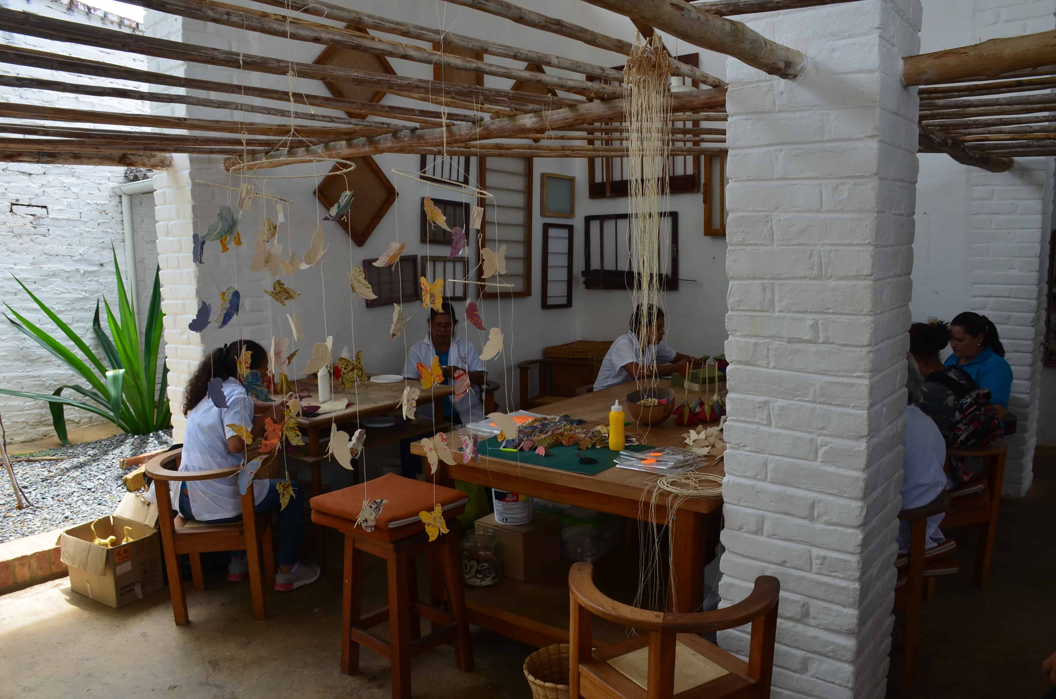 Women creating crafts from the paper at the Barichara Paper Workshop in Barichara, Santander, Colombia