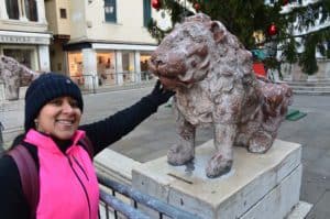 Marisol with one of the lions at Piazzetta dei Leoncini in Venice, Italy