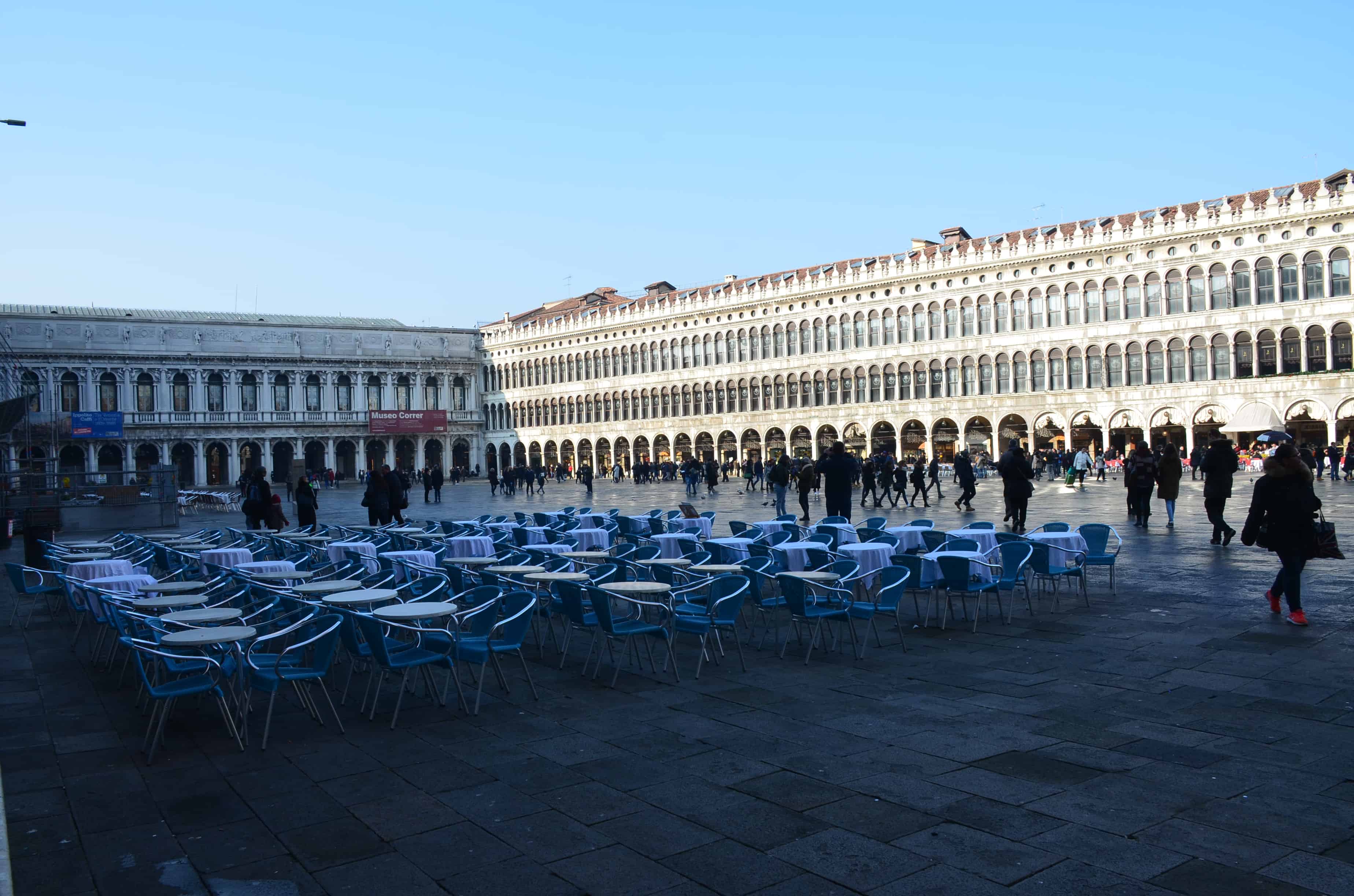 Chairs from Caffè Aurora with the Old Procuratie in the background in Venice, Italy