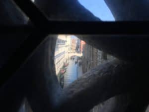 Looking out the window from the Ponte dei Sospiri at the Palazzo Ducale in Venice, Italy