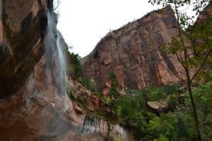 Water seeping over the cliff on the Emerald Pools Trail at Zion National Park in Utah