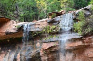 Water seeping over the cliff on the Emerald Pools Trail at Zion National Park in Utah