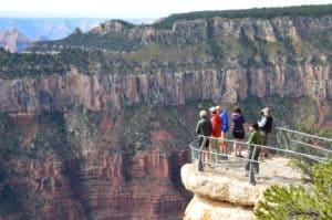 Visitors enjoying the view from Bright Angel Point at Grand Canyon National Park in Arizona