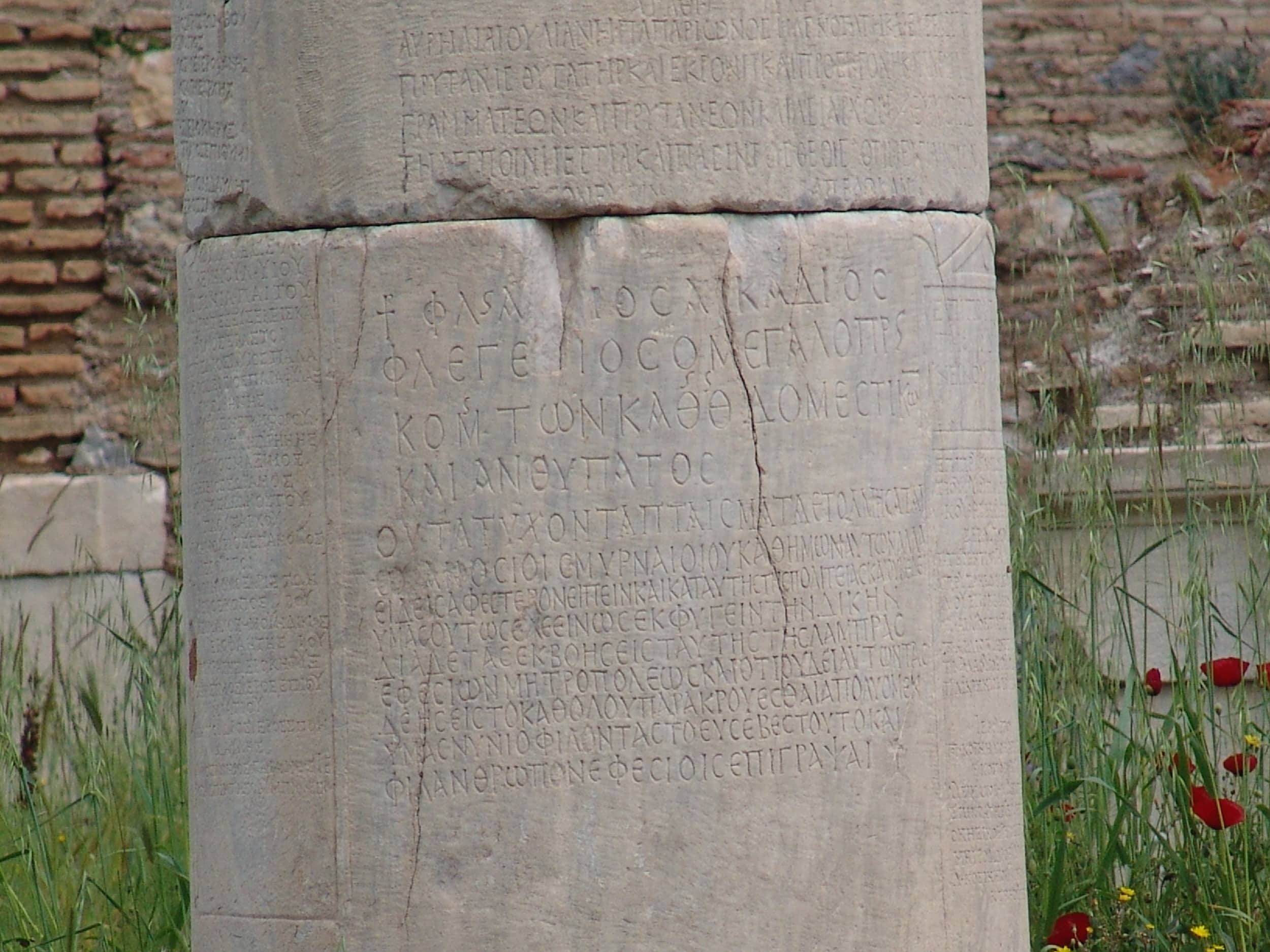 Pillar with Greek script in front of the Prytaneum