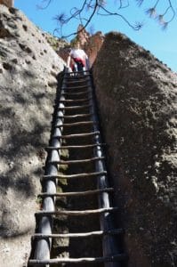 Climbing a ladder at Alcove House at Bandelier National Monument in New Mexico