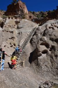 Hikers climbing up at Alcove House at Bandelier National Monument in New Mexico