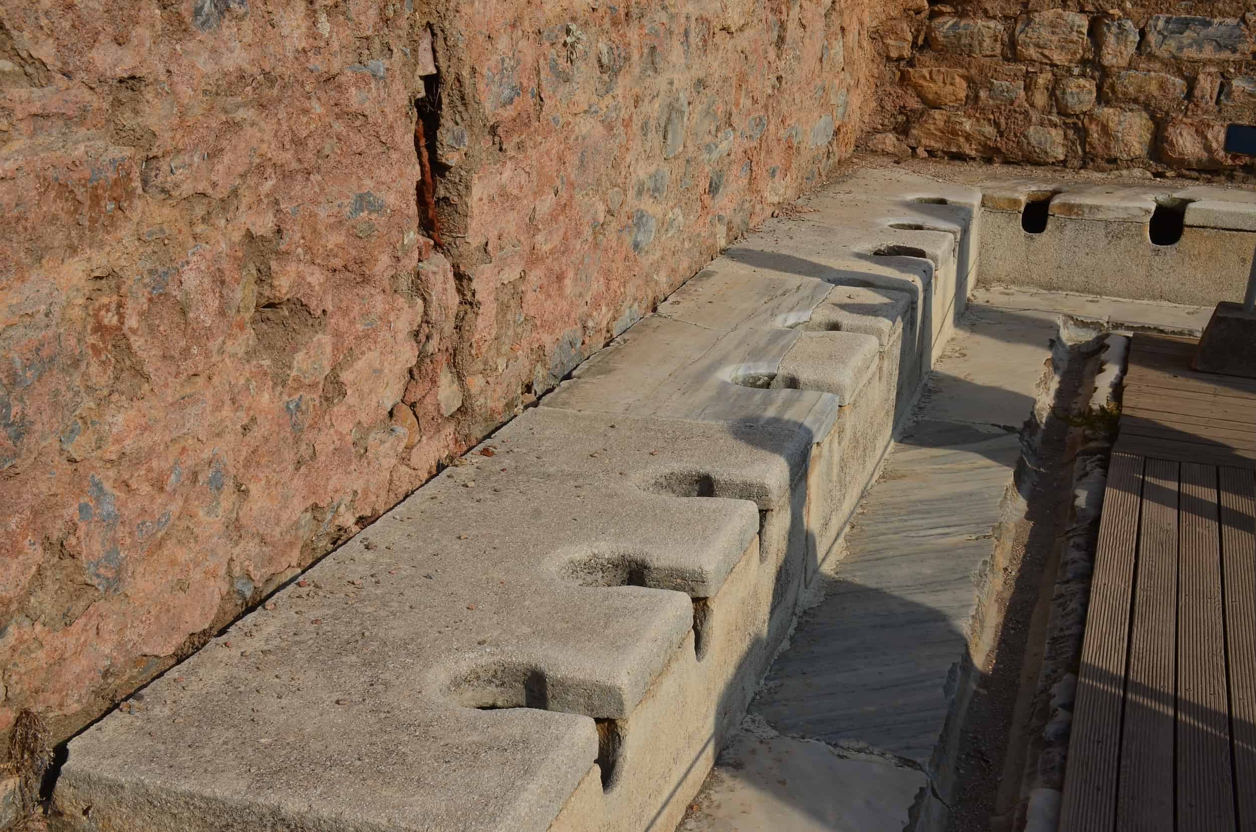 Row of toilets at the Latrines on Curetes Street in Ephesus