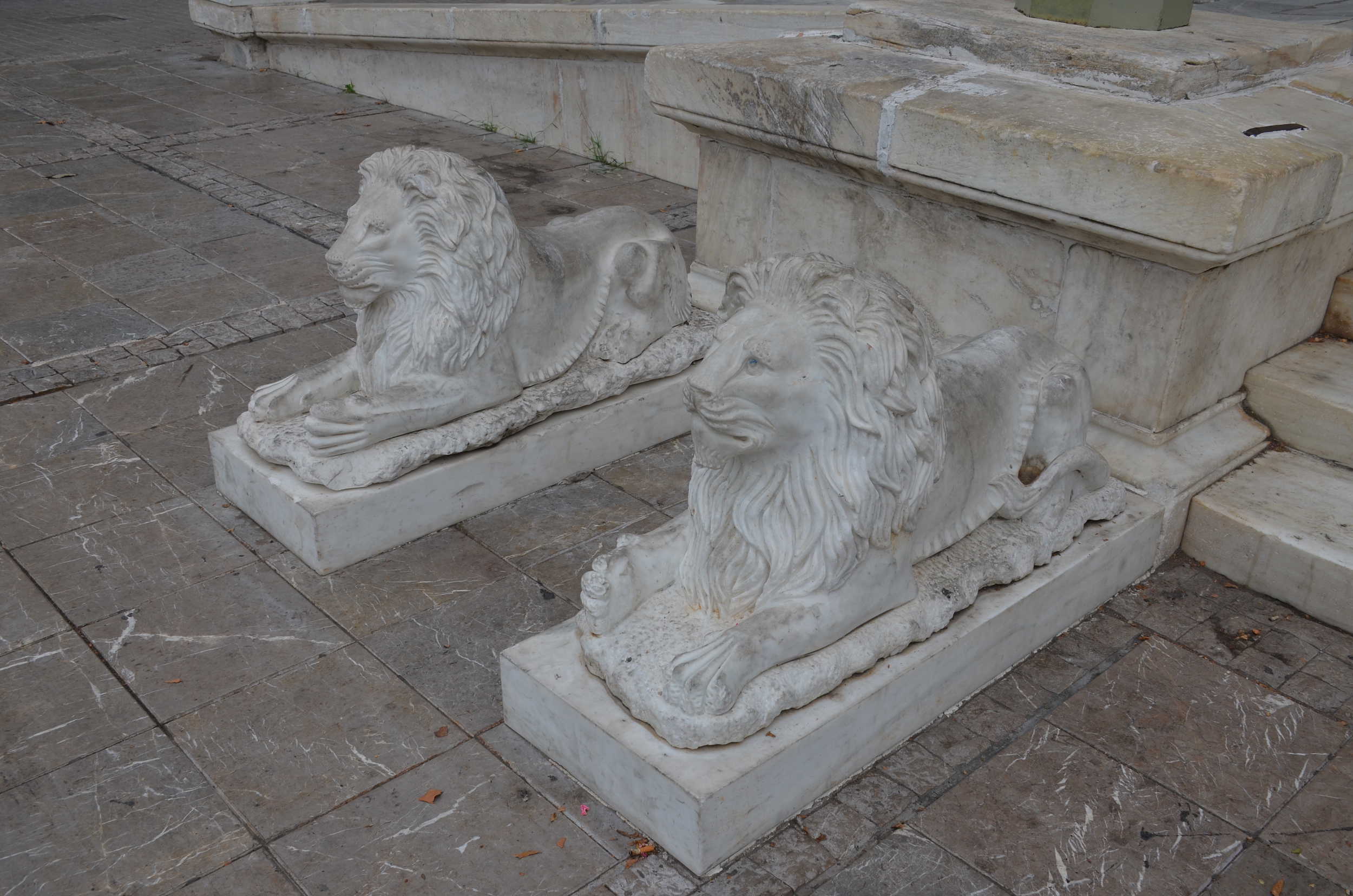 Marble lions guarding the steps to the Metropolitan Cathedral on Mitropoleos Square in Athens, Greece