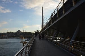 Walking across the Golden Horn Metro Bridge in Istanbul, Turkey