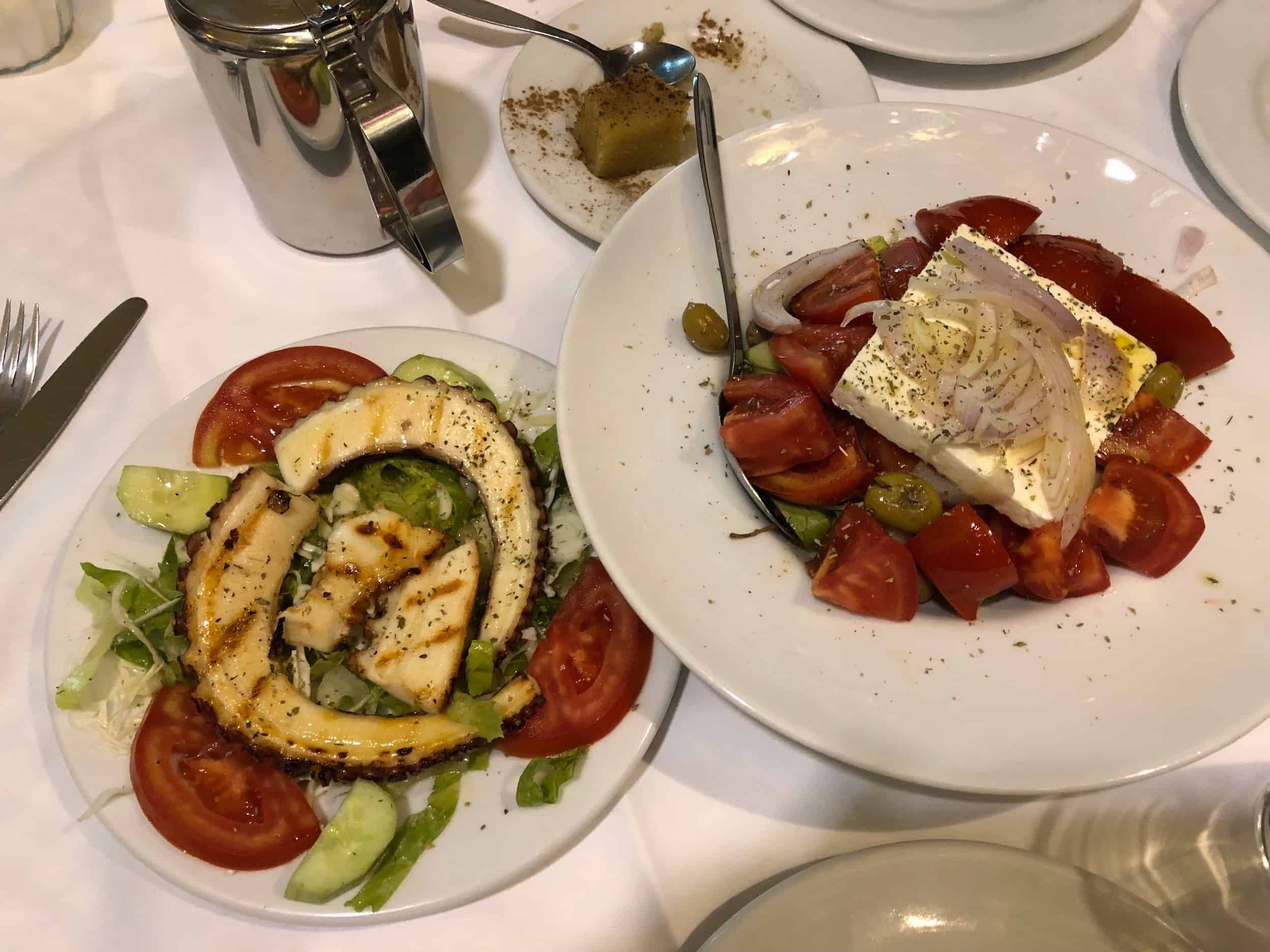 Grilled octopus (left) and village salad (right) at Ta Giouvetsakia in Athens, Greece