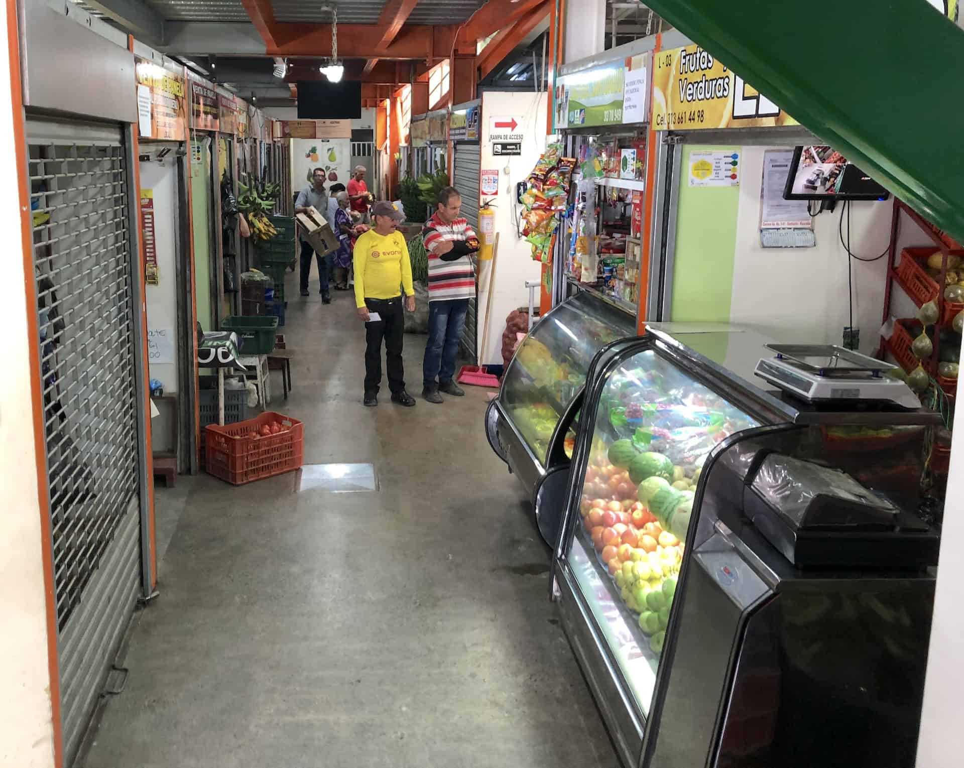 Stalls selling fruits and vegetables on the lower level of the Plaza de Mercado