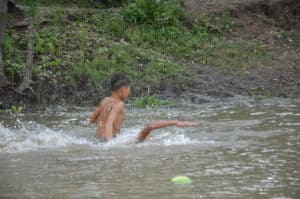 Boys swimming in the river in Peñoncito