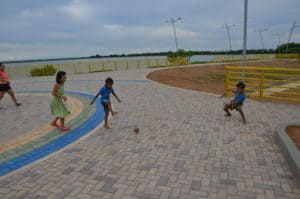 Children playing football on the promenade