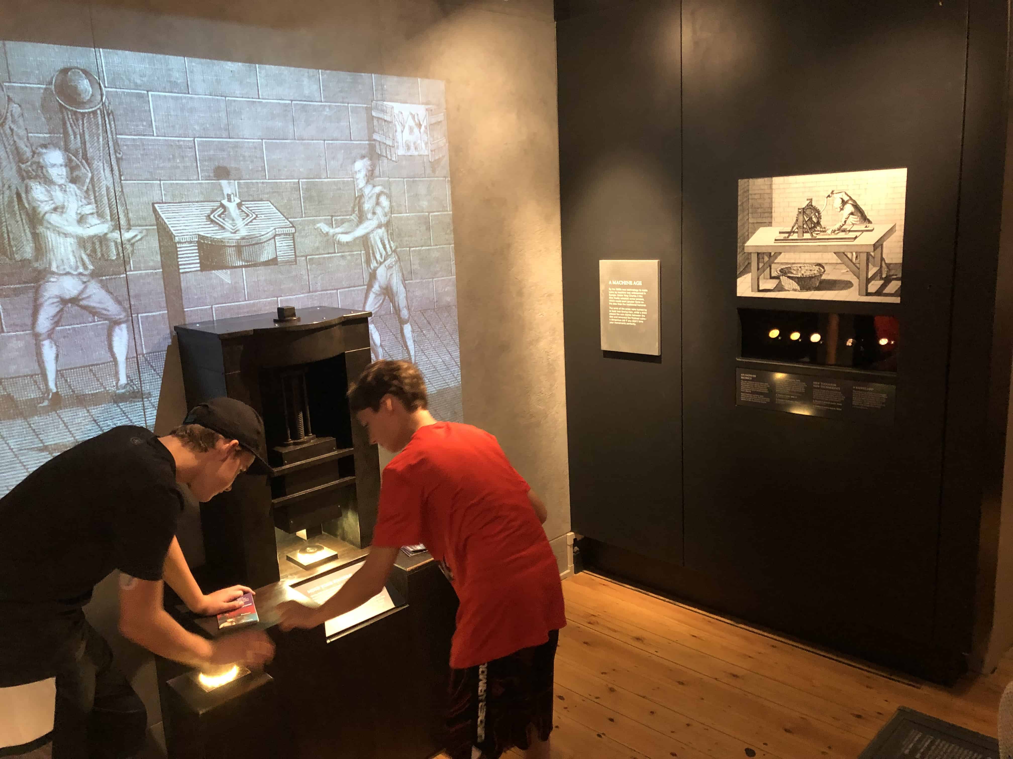 Guests in the museum at the Royal Mint at the Tower of London in London, England