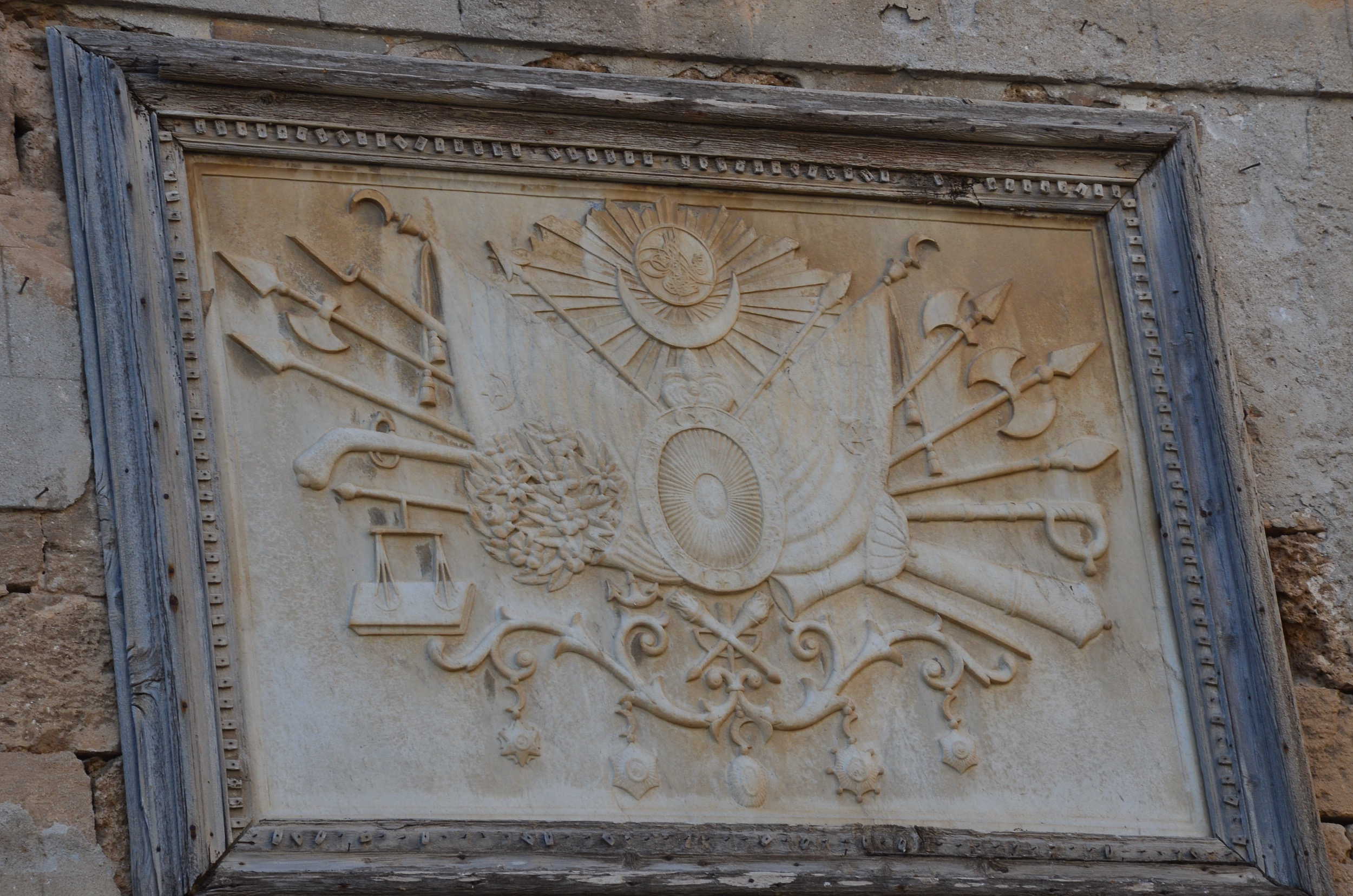 Ottoman coat of arms on the clock tower on Khan al-Umdan in Acre, Israel