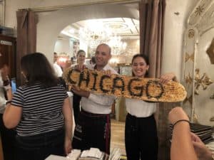 Wait staff bringing out bread with "Chicago" written on it at Hatay Medeniyetler Sofrası in Istanbul, Turkey