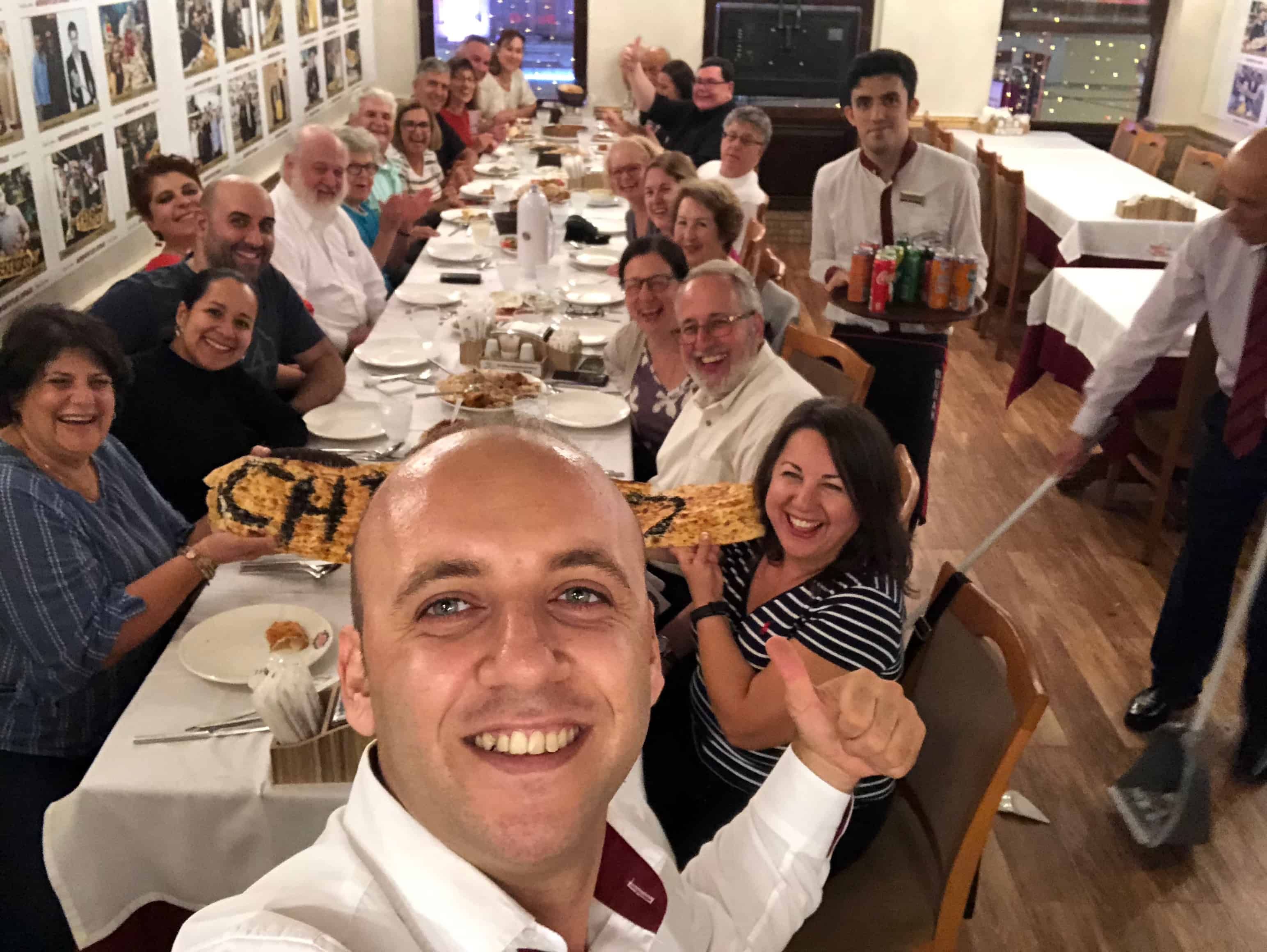Waiter taking a selfie with the group at Hatay Medeniyetler Sofrası