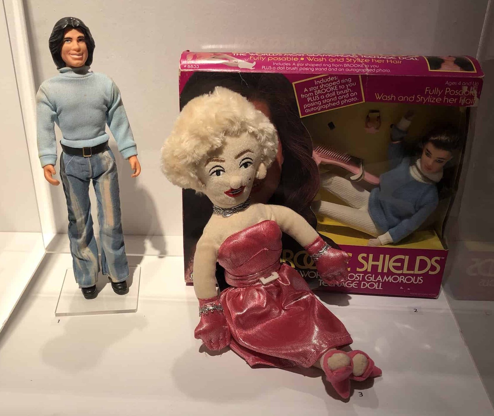 Dolls of John Travolta, Marilyn Monroe, and Brooke Shields