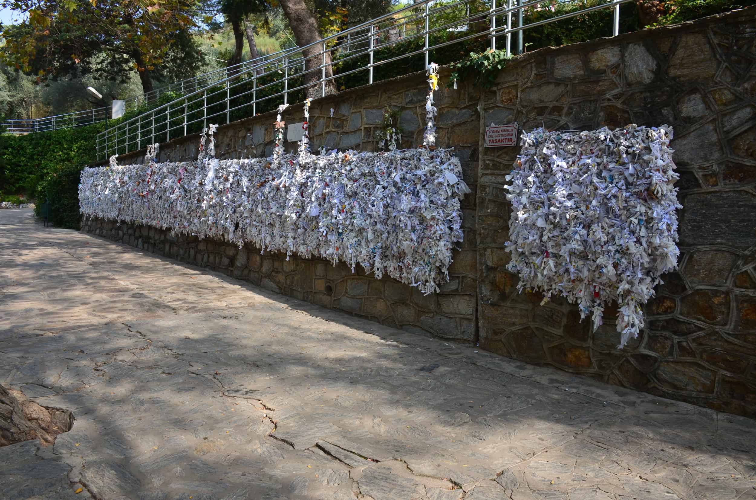 Wall with cloths and prayers at the House of the Virgin Mary in Selçuk, Turkey