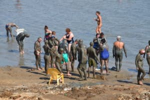 Visitors rubbing mud on their bodies at Biankini Village at the Dead Sea in Palestine