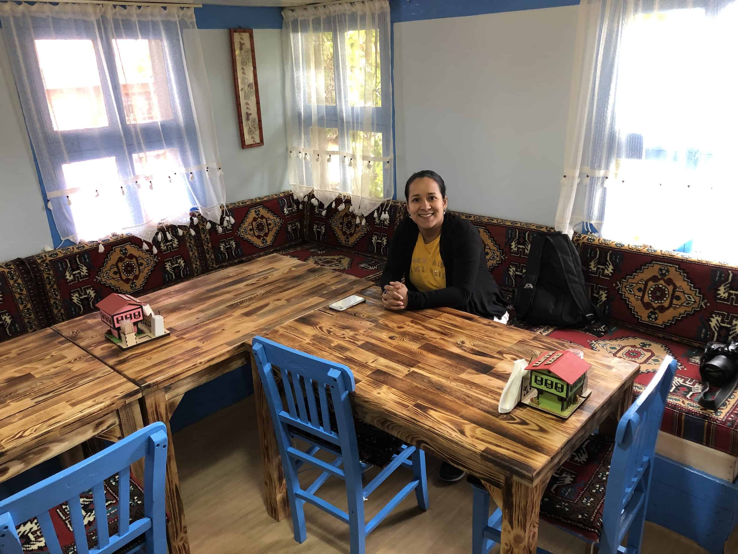 Marisol sitting in the dining room at Arya Mantı