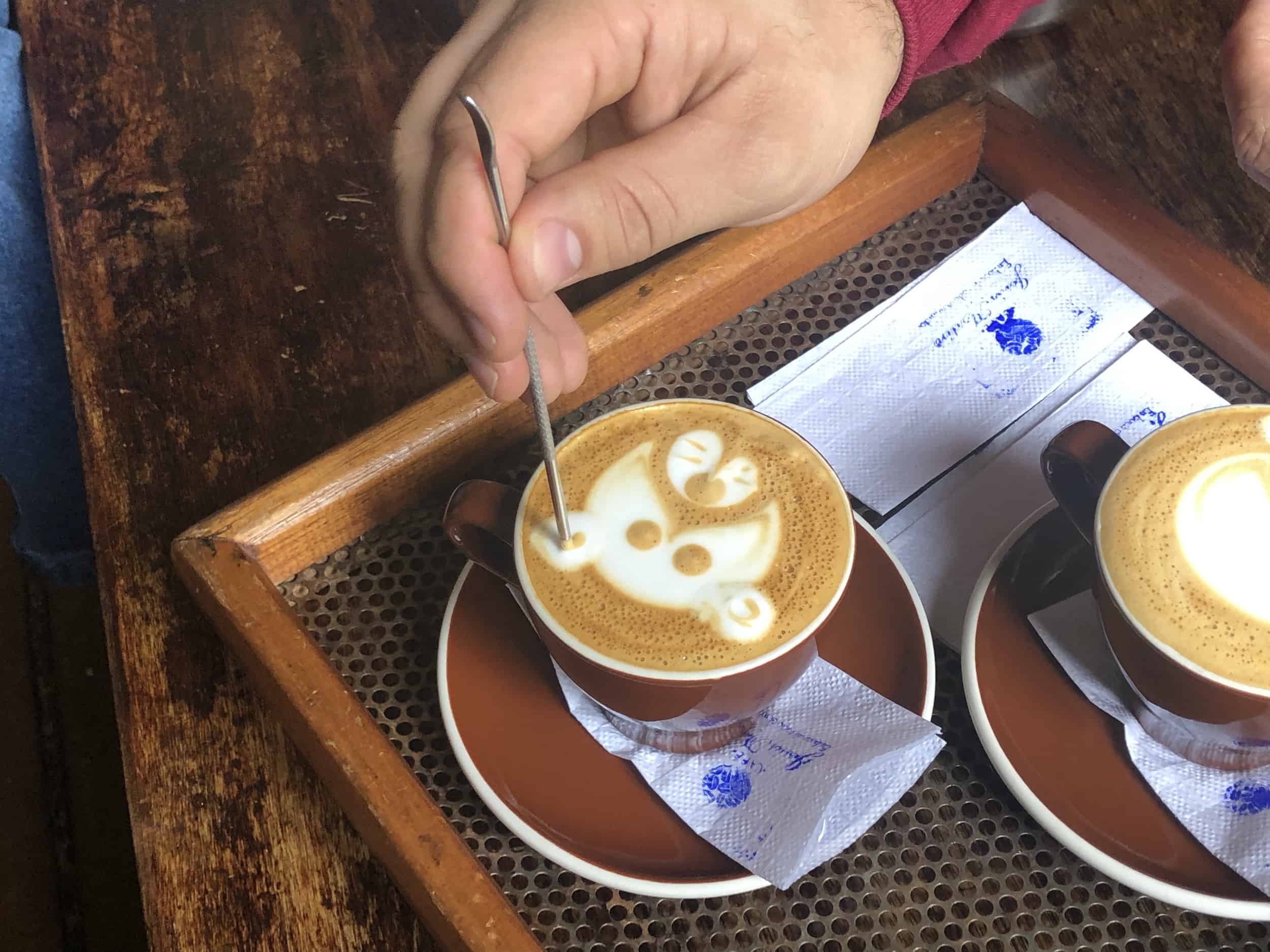 Barista creating cappuccino art on the Café Jesús Martín Coffee Tour in Salento, Colombia