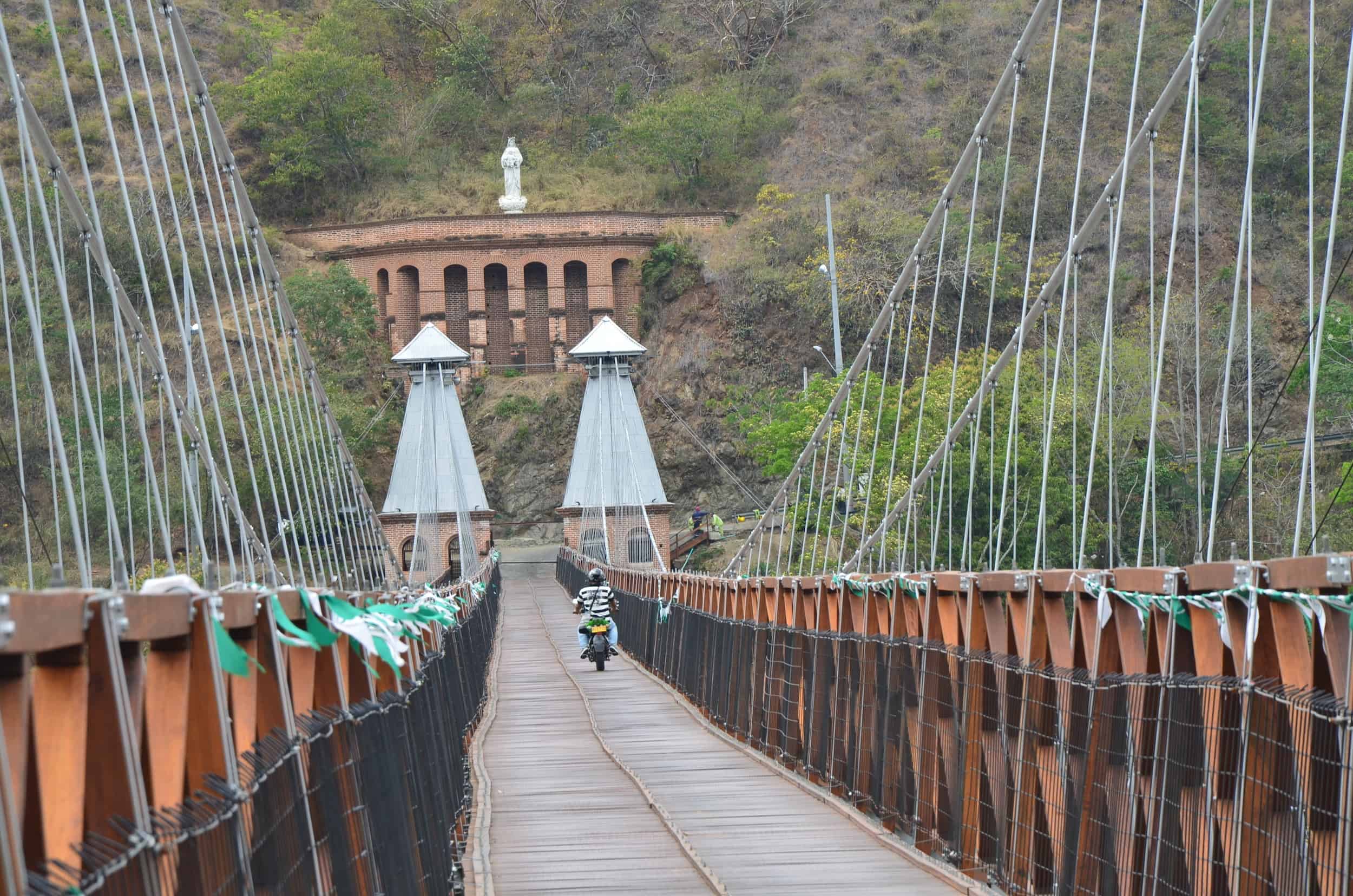 Motorcycle crossing the bridge at the Puente de Occidente in Santa Fe de Antioquia, Colombia