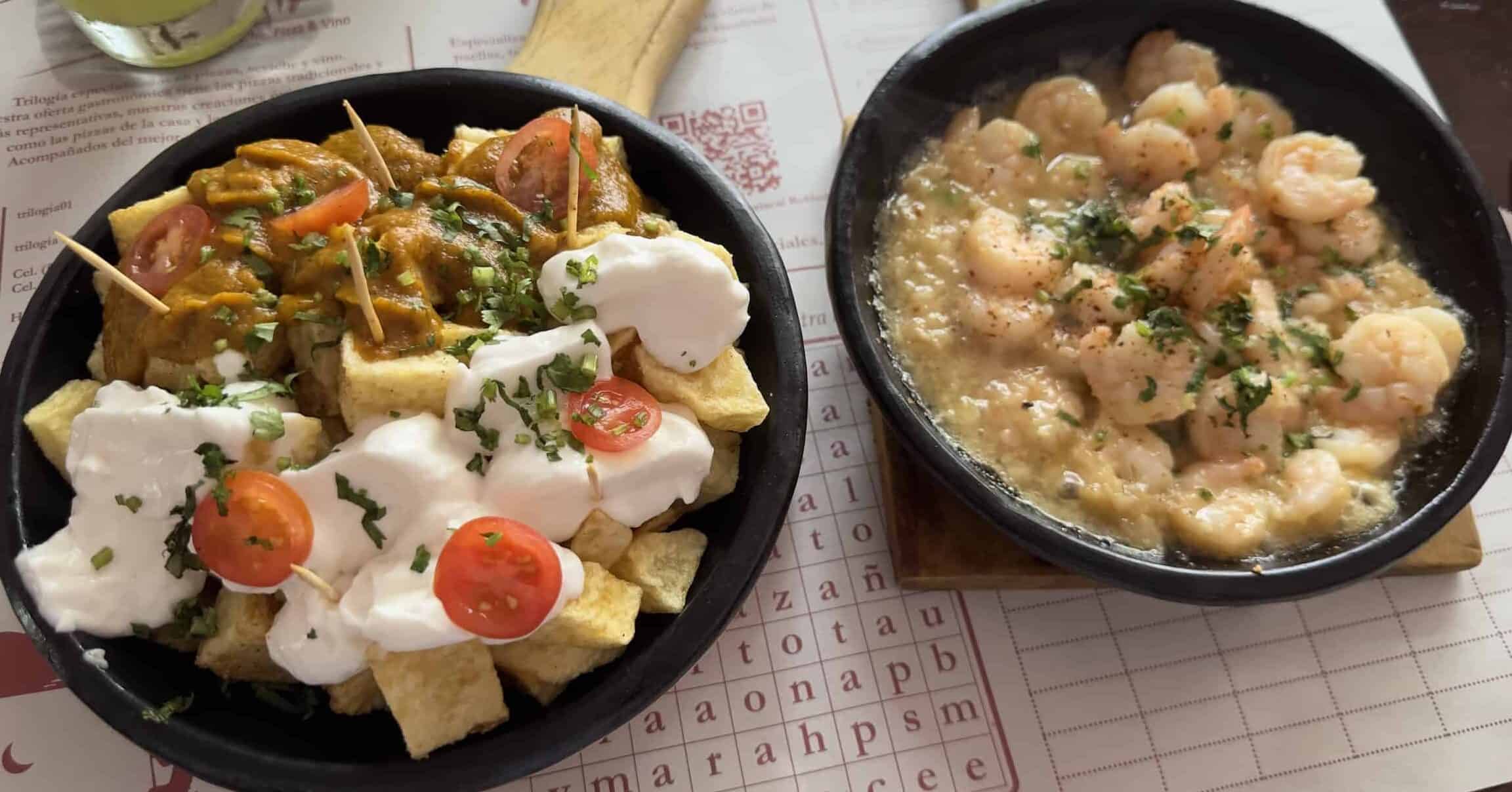 Patatas bravas and patatas alioli (left) and garlic shrimp (right) at El Español in Santa Fe de Antioquia, Colombia