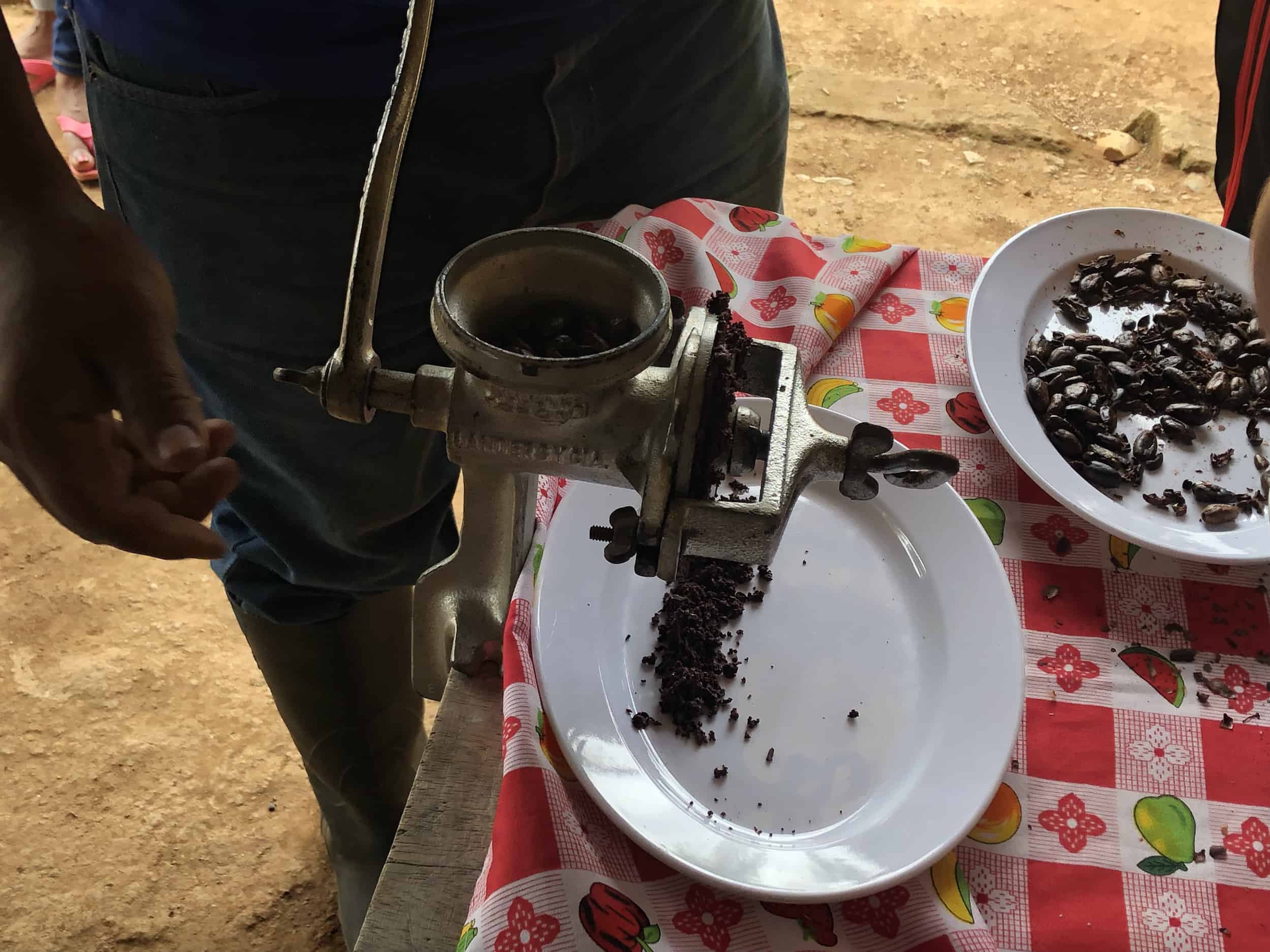Grinding the cacao beans on the cacao tour near Buritaca, Colombia