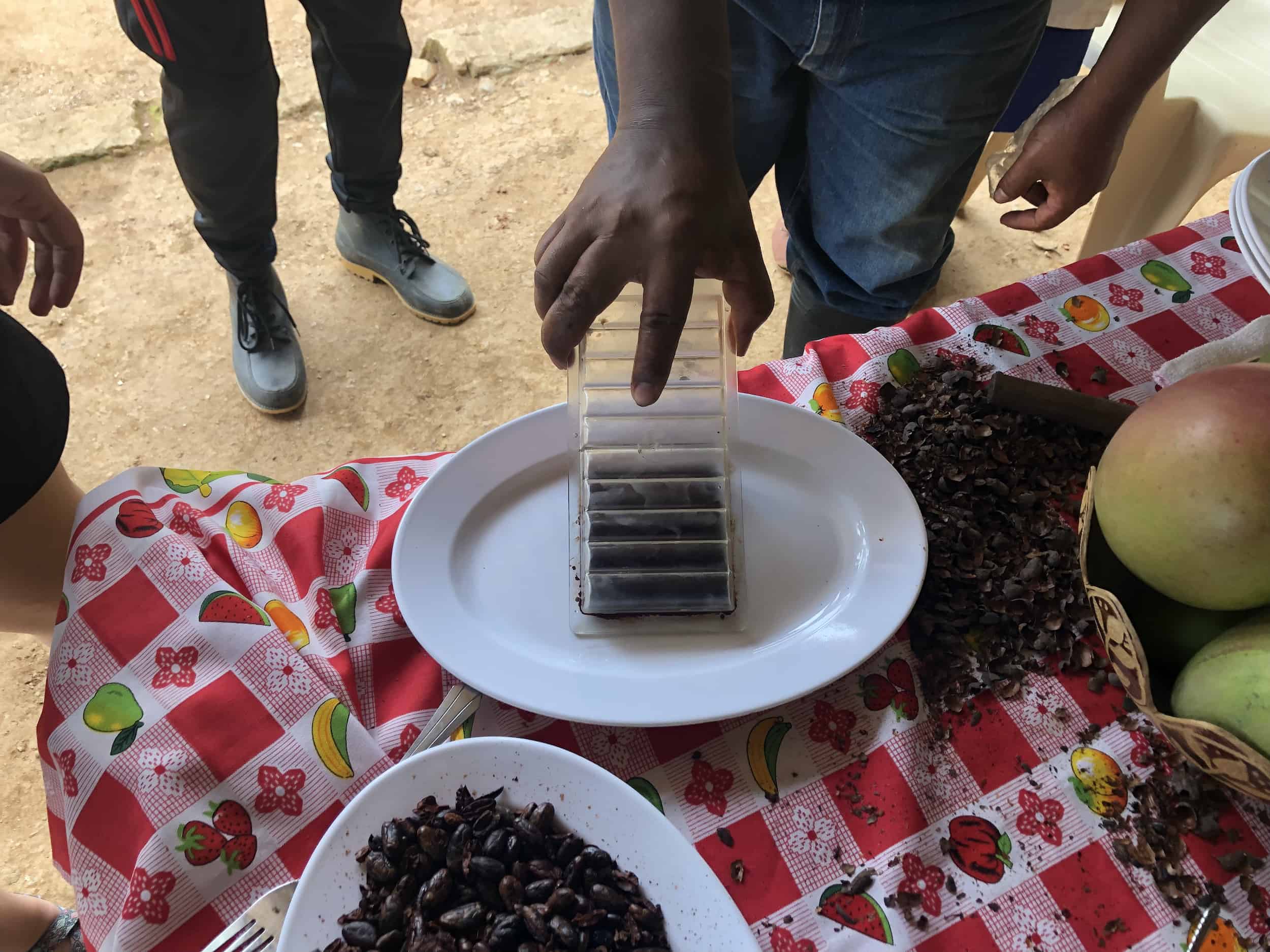 Removing the finished chocolate bar from the mold on the cacao tour near Buritaca, Colombia