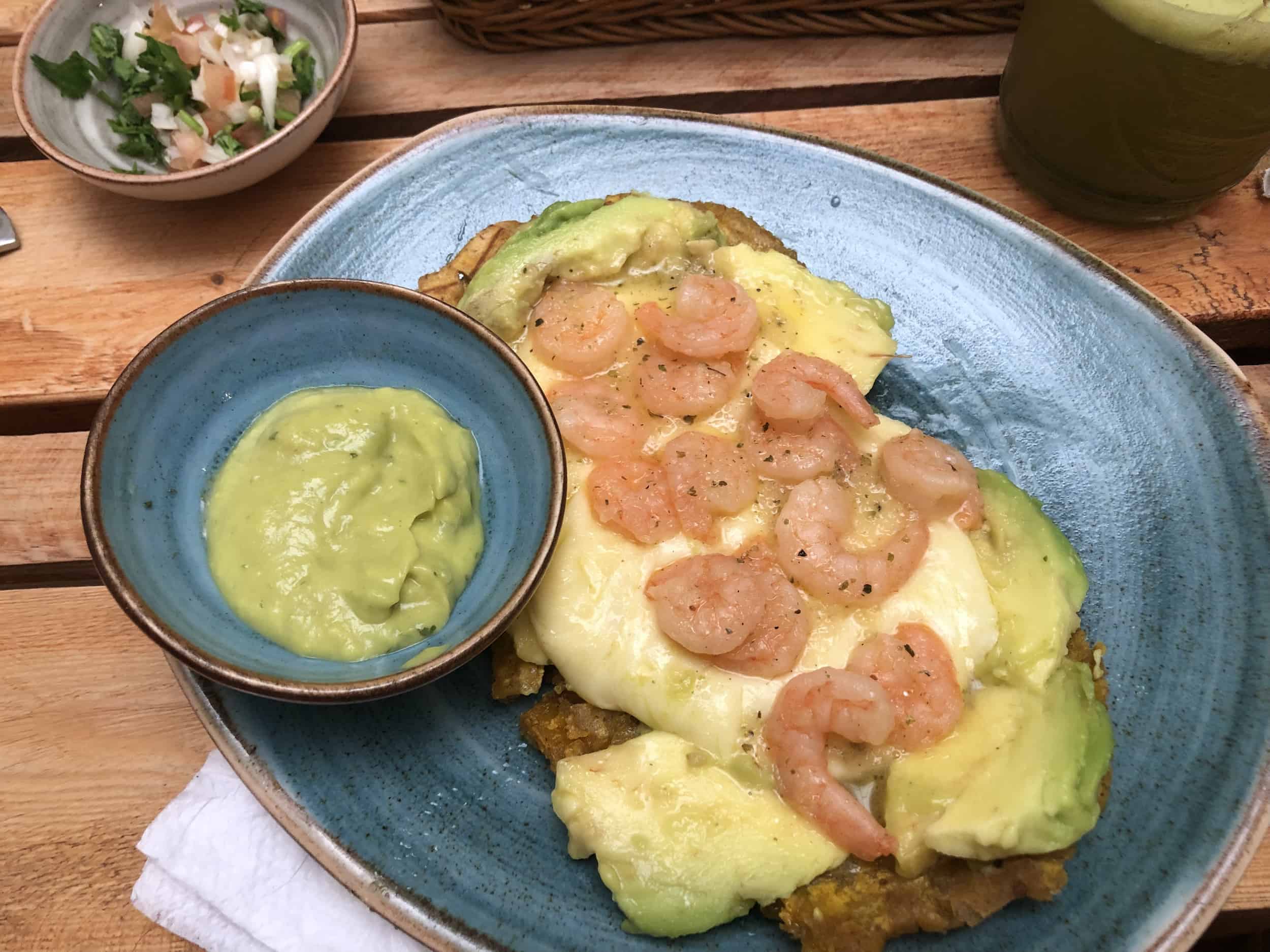 Patacón with shrimp, avocado, and melted cheese at Realismo Mágico in Jardín, Antioquia, Colombia