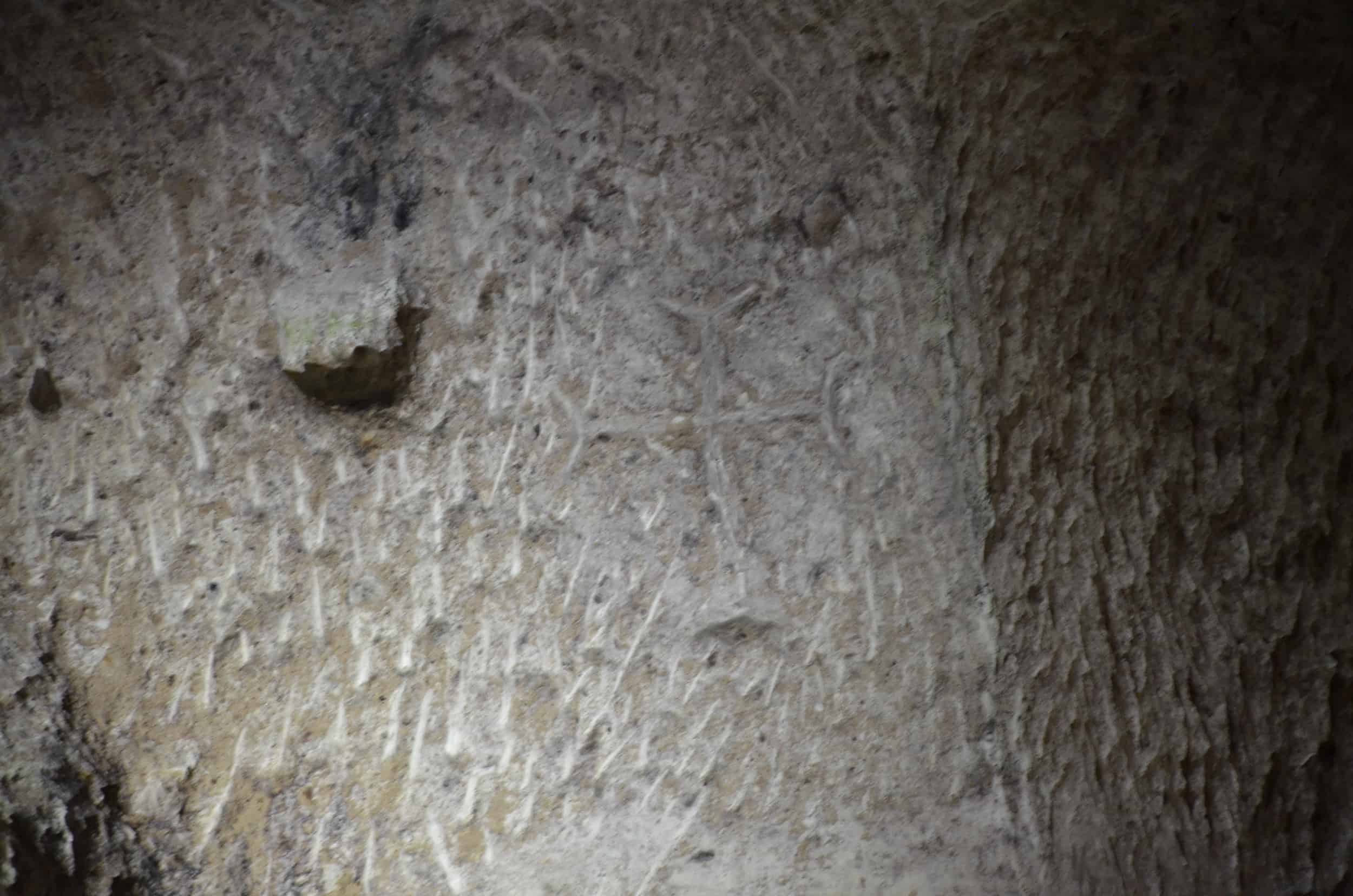 Cross carved into the wall of a cave