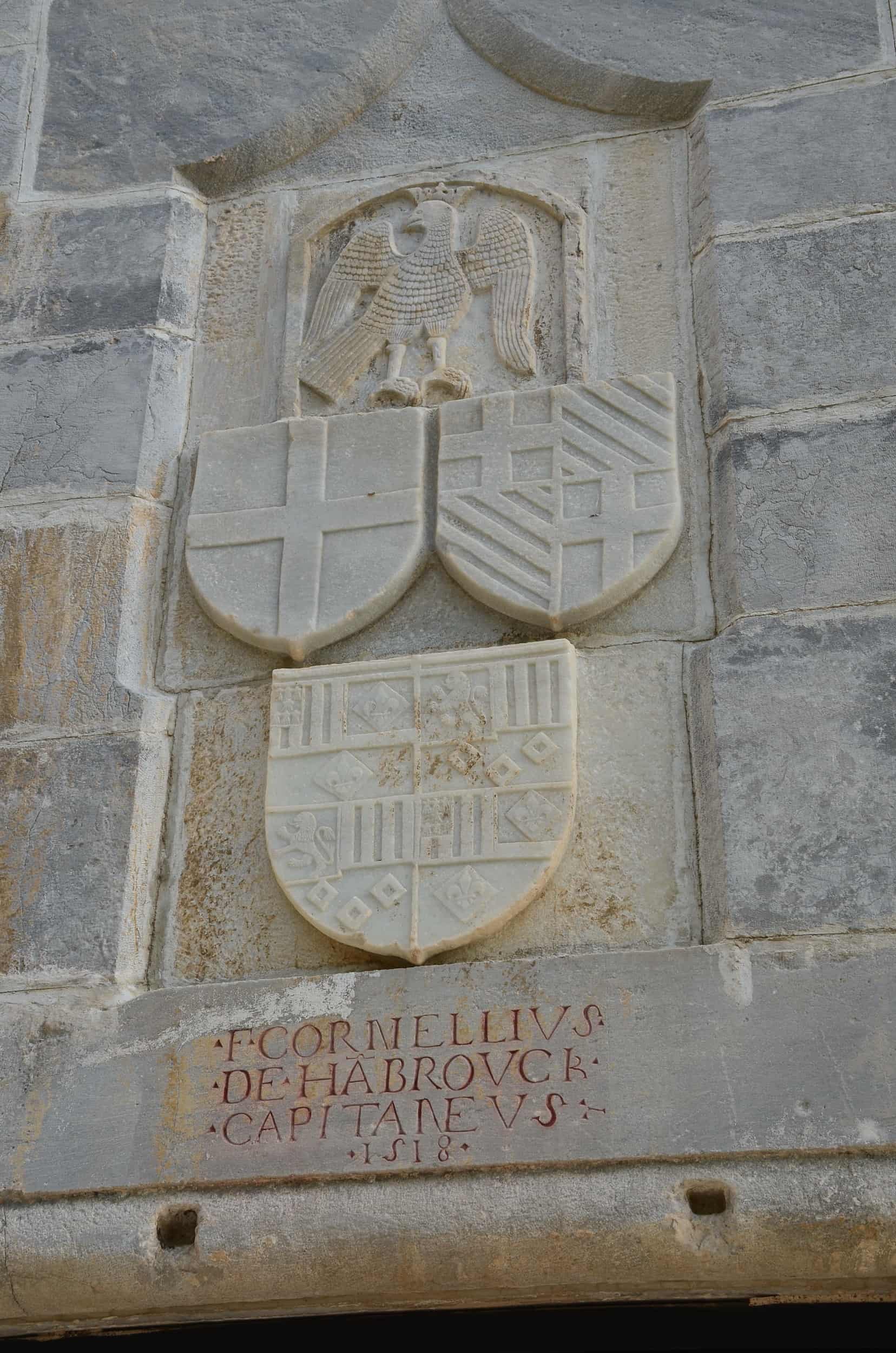 Coats of arms of the Order of the Knights of Saint John merged with that of Fabrizio del Carretto (top left); the Order of the Knights of Saint John (top right); and castle commanders Cornelius Hambroeck and Wallaim Berges (bottom)